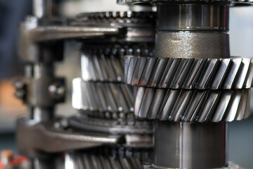 Detailed stack of helical gears and shafts from a disassembled vehicle transmission, showcasing the mechanical complexity and precision engineering of the components.