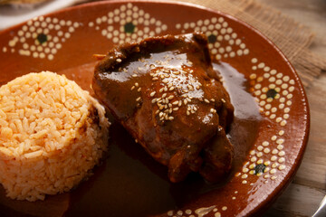 Mole Poblano. Chicken with Mole. Typical dish, emblematic of Mexican food made with a mixture of numerous ingredients. Mole sauce is commonly served with chicken or turkey.