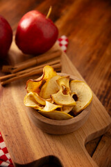 Apple Chips, thin slices of dehydrated and baked apple, sprinkled with cinnamon powder, easy recipe for a healthy snack.