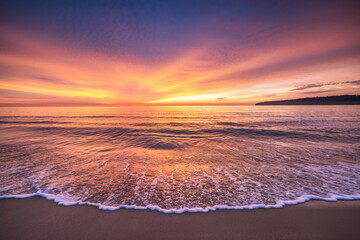Beach sunrise over the tropical sea horizon and beach