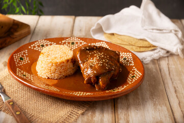 Mole Poblano. Chicken with Mole. Typical dish, emblematic of Mexican food made with a mixture of numerous ingredients. Mole sauce is commonly served with chicken or turkey.