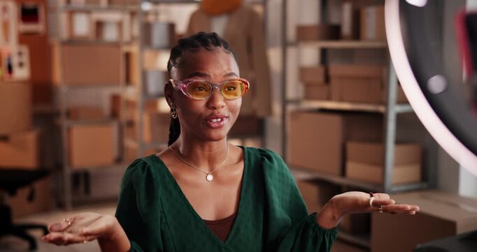 Girl, sunglasses and ring light with recording, review or talk with startup for online audience. Black woman, dropshipping and influencer with content creation, fashion or social media post at store