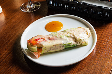 Bright and fresh spring roll filled with crisp vegetables, accompanied by a tasty dipping sauce