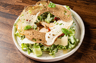 Grilled chicken and fresh greens are beautifully served with toasted bread for a delightful dish