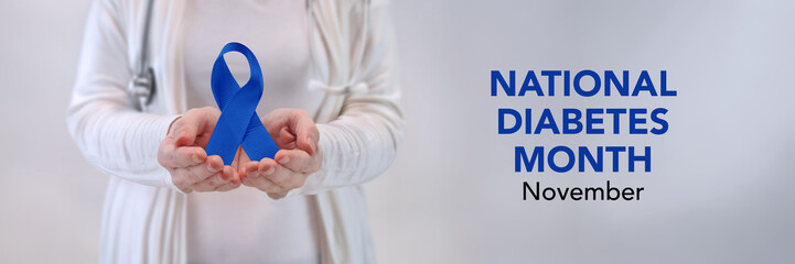 Doctors Hands Presenting Blue Awareness Ribbon - Diabetes Awareness Concept