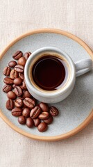 Fototapeta premium Rustic Flat Lay of Roasted Coffee Beans and a Cup of Hot Coffee on a Textured Plate with a Neutral Background