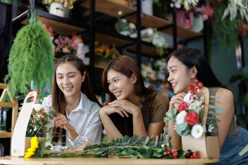 Asian women florists arranging flowers in flower shop