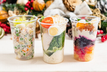 Three fresh salads in clear glass cups showcase a mix of ingredients, perfect for any meal