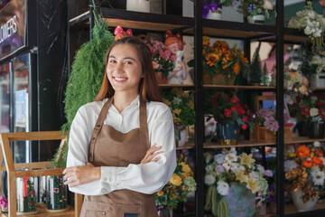 Happy young florist smiling in flower shop