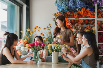 Women learning flower arranging in floral shop