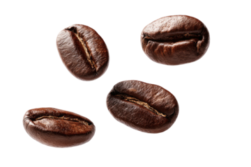 Four roasted coffee beans isolated on a black background