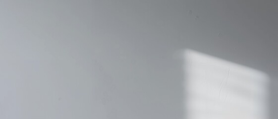 Blurred image of a light-colored surface with a faint rectangular shape in the corner