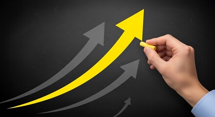 Hand drawing yellow growth arrow on blackboard representing business success