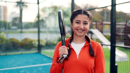 Face, happy woman and padel on court for sports game, club tournament and skill development. Person, smile and athlete outdoor with racket for tennis competition practice, workout goals and fitness. - Powered by Adobe