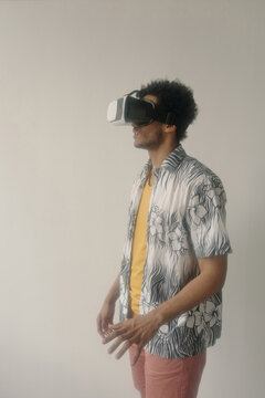 Young male student lost in virtual reality vertical medium long portrait