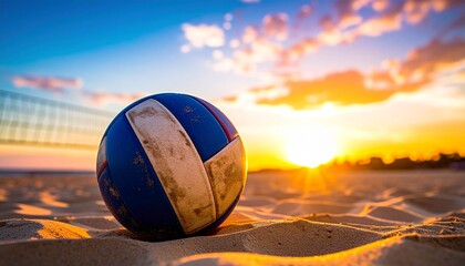 A weathered volleyball rests on the soft sand of a beach court, with a beautiful golden sunset and net in the background