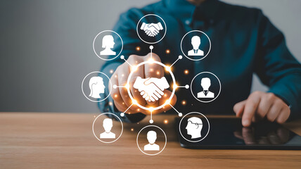 Man touching virtual handshake icon surrounded by people icons representing business networking and collaboration