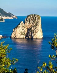Sunlit Sea Stack off a Mountainous Coastline