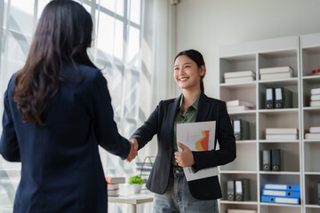 Businesswomen shaking hands celebrating successful partnership