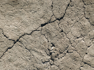 Top view of rocks and old, gray, cracked concrete. Grunge, artificial backdrop.