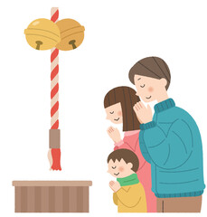 初詣でお参りをする家族