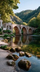 Old Stone Bridge Spanning a Clear River in a Lush Green Forested Valley Bathed in Warm Sunlight