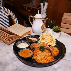 Delicious Chicken Steak Served with Sides in a Restaurant