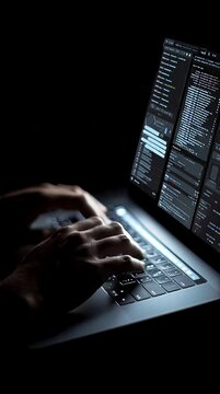 Hand coding interface on laptop screen in dark mode