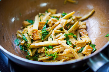 Stir-fried bamboo shoots with tofu and vegetables in pan
