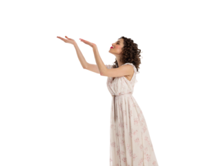 Woman in floral dress with curly hair looking upward with raised hands presenting gesture, isolated on a transparent background