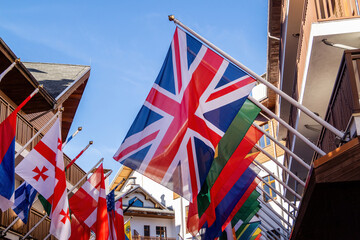 Flags of the world display in vibrant street during sunny day in a lively town center