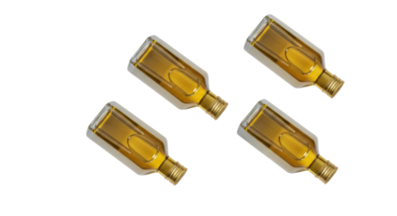Four golden liquor bottles arranged in a transparent composition, creating a visually appealing and minimalist composition.