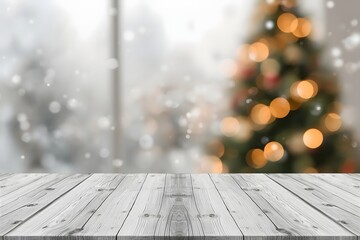 Empty white wooden table top with abstract muted blur christmas tree and snow fall background with bokeh light.