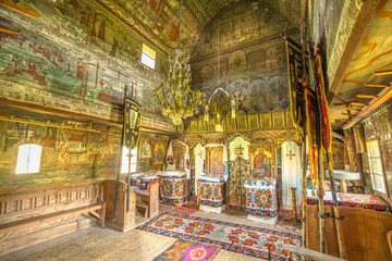 Maramures, Romania - Aug 14, 2025: Saint Parascheva Church interior in Poienile Izei, Maramures in Romania. ornate wooden Romanian Orthodox space with vivid frescoes, icons, carved iconostasis