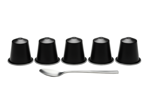 Five identical deep matte black cylindrical espresso pods in a row with a polished stainless steel spoon on a seamless transparent background, high-key studio shot, commercial product design concept