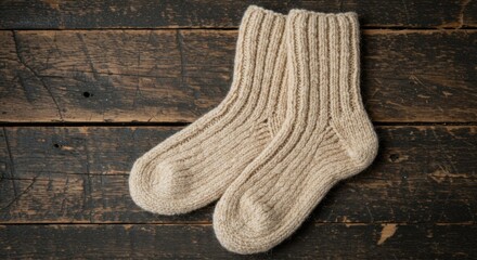 Pair of Beige Knit Wool Socks on Rustic Wooden Background