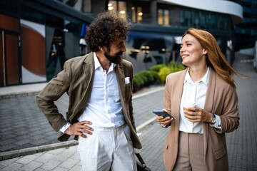 Business people talking and walking outdoors in the city