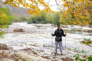  young girl with a backpack is hiking alone in nature