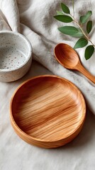 High Resolution Studio Shot Of A Blank Wooden Plate And Ceramic Bowl With A Wooden Spoon And Green Leaves On A Glittery Fabric Background