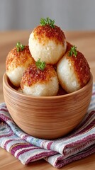 Handmade Glutinous Rice Balls Topped with Savory Sauce and Fresh Parsley Garnishes Served in a Wooden Bowl on a Textured Napkin with Soft Natural Lighting