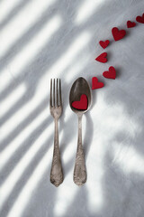 Romantic dinner setting with hearts and shadows