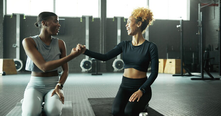 Fist bump, teamwork and women in gym for fitness, pilates or training with success, achievement or...
