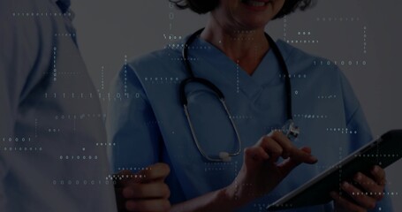 Tapping nurse wearing blue scrubs with stethoscope and using tablet at clinic, binary code overlay