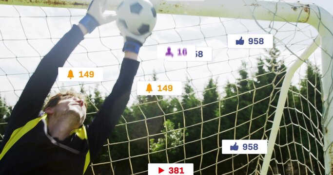 Leaping goalkeeper in gloves catching soccer ball at goal net, with notification icons, copy space - Powered by Adobe