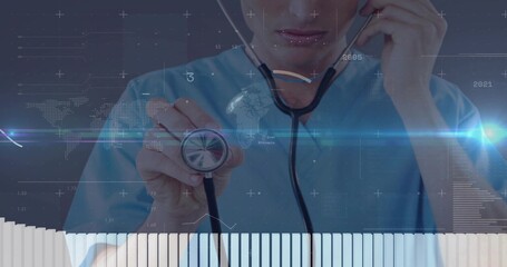 Presenting male doctor holding stethoscope while speaking into handset in office with data overlays