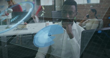 Studying data analyst in white shirt examining holographic grid and charts at office desk, teamwork