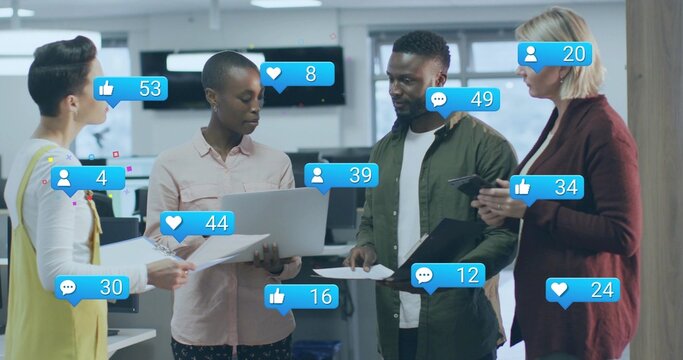 Four professionals in business attire reviewing social media metrics in office, with laptops docs