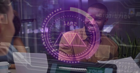 Collaborating Black man and woman discussing project in office with laptop and digital overlay