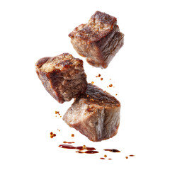 Cubes of cooked meat with spice fragments falling