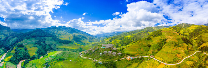 Fototapeta premium Aerial view of golden rice terraces at Mu Cang Chai town near Sapa city, North of Vietnam. Beautiful terraced rice field in harvest season in Yen Bai province.